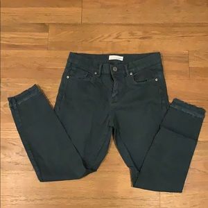 Turquoise jeans with frayed bottom